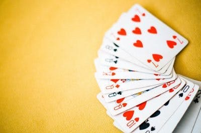playing cards sitting on yellow background