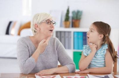 speech therapist teaching exercises to pediatric stroke survivor