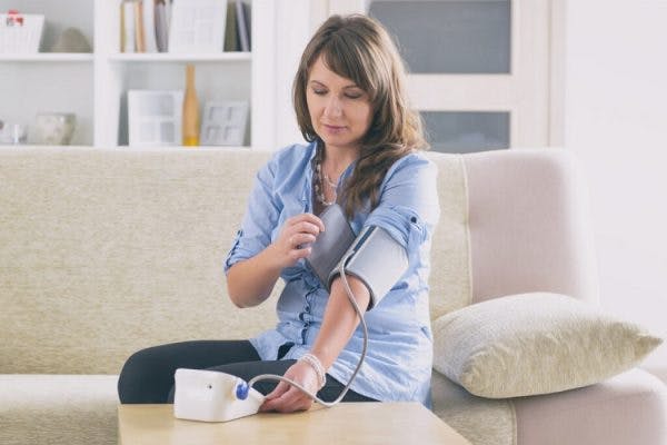 woman with autonomic dysreflexia taking blood pressure measurement