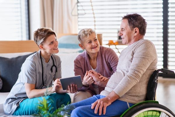 Therapist talking to patient and his wife about Severe TBI Recovery