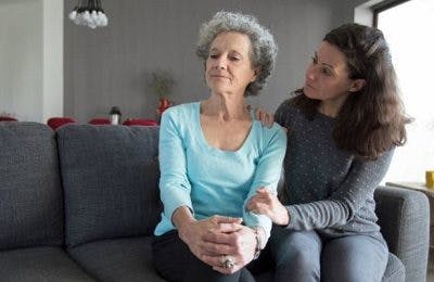 daughter on couch trying to talk to angry mother, wondering how to help someone who had a stroke 