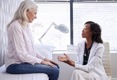 doctor discussing treatment with elderly patient