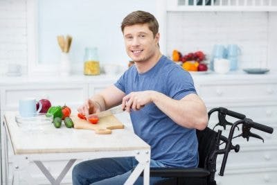 man who is paralyzed from the waist down practicing activities of daily living independently