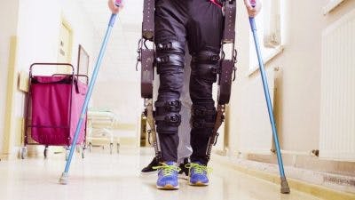 individual with complete paraplegia using exoskeleton to walk again