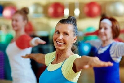 senior woman practicing balance exercises in exercise class