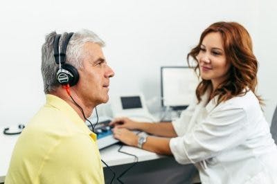 man wearing headphones taking a hearing test to determine whether he has sensorineural hearing loss after head injury