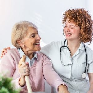 nurse smiling at patient with primary progressive aphasia