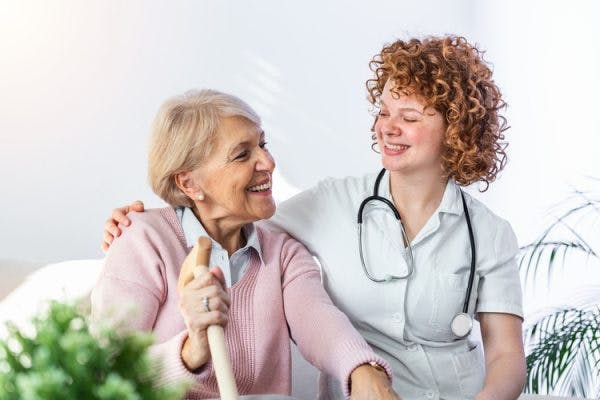 nurse smiling at patient with primary progressive aphasia