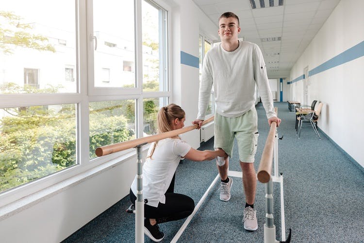 young man working on physical therapy for spinal cord injury treatment