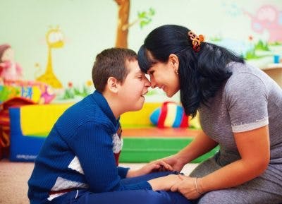 kid with non-verbal cerebral palsy interacting with mom