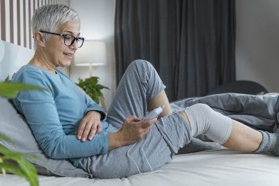 senior woman using electrical stimulation for her chronic stroke effects