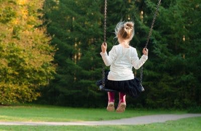 young girl with cerebral palsy swinging