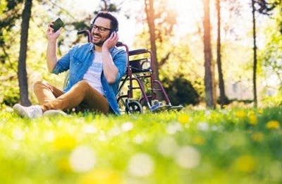 adult with cerebral palsy using wireless headphones