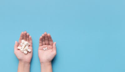 sugar pills in one hand (placebo) and actual pills in the other