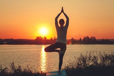 young woman with tbi practicing yoga for recovery