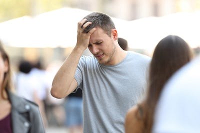 man experiencing anxiety due to overstimulation after brain injury