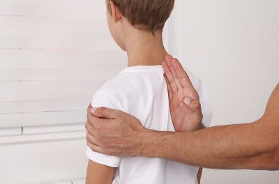 child with cerebral palsy getting checked for abnormal posture