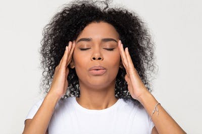 woman practicing deep breathing to calm down after overstimulation