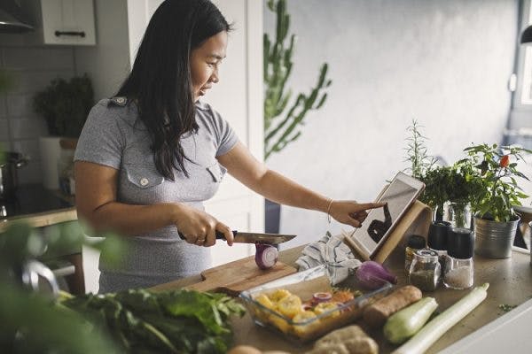 woman preparing healthy food after learning how TBI and the immune system are connected