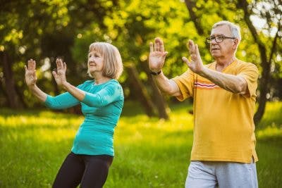 elderly couple practicing tai chi to improve balance after stroke