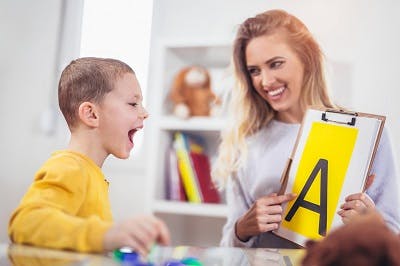 Speech therapist teaches boy with cerebral palsy to say the letter A