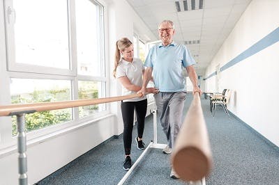 man with paraplegia after thoracic spianl cord injury practicing walking