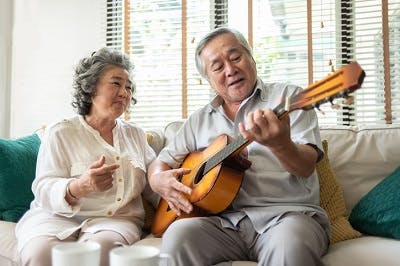 elderly couple using melodic music therapy to treat aphasia after concussion