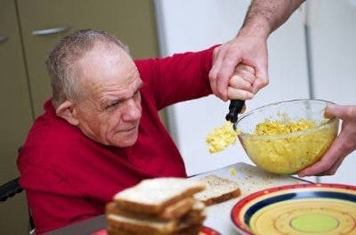 TBI patient practicing adaptive technique learned in occupational therapy