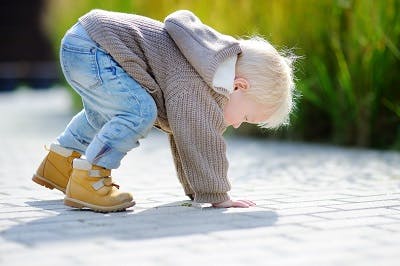 toddler with ataxic cerebral palsy frequently falling due to impaired balance and coordination