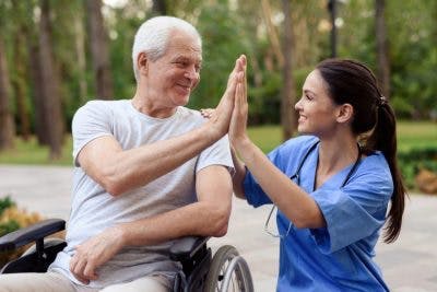 nurse helping man in wheelchair