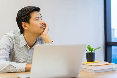 man looking out the window because he cannot focus due to brain injury