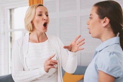 terapeuta del habla que muestra a un joven superviviente de un accidente cerebrovascular cómo hacer ejercicios de voz