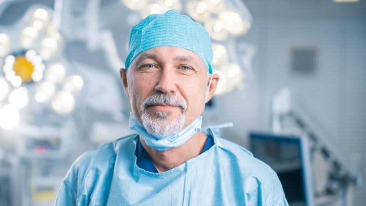 surgeon in operating room about to perform spinal cord surgery