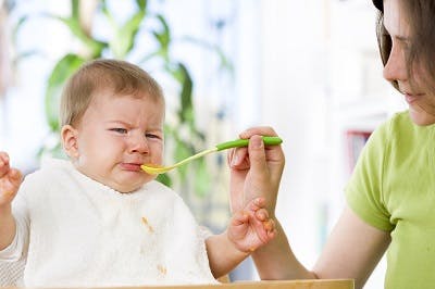 baby with cerebral palsy struggling to eat because of facial motor impairments