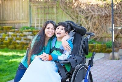 boy with severe cerebral palsy and his mom