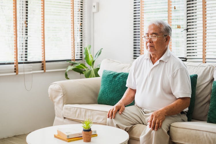 stroke survivor sitting on a couch with eyes closed doing mental practice
