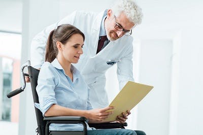 doctor explaining paralysis treatment and recovery process