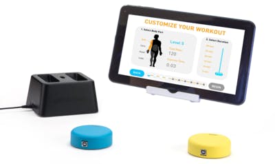 FitMi tablet with yellow and blue "pucks" for interactive stroke rehab equipment