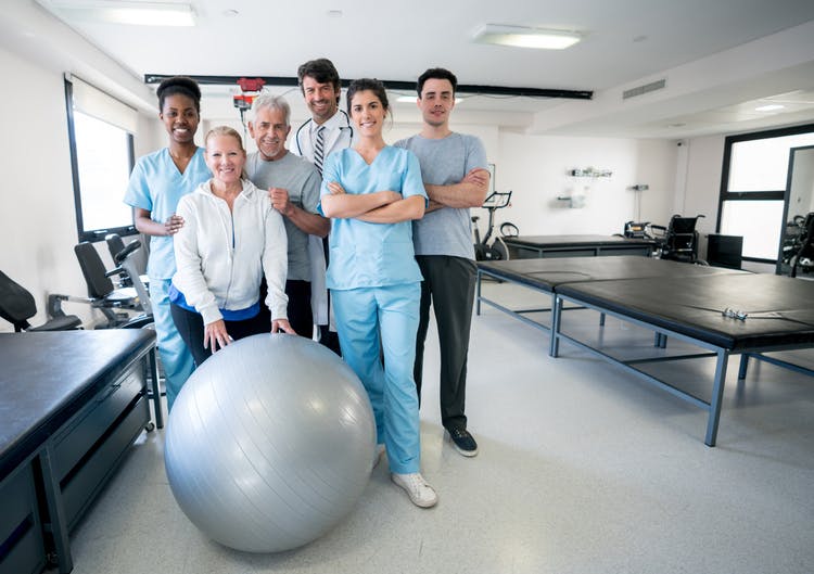 Diverse team of physical therapists at a rehabilitation clinic for stroke recovery treatment