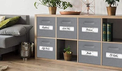 living room with bookshelf and bins that are clearly labeled for adaptive equipment after traumatic brain injury