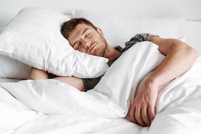 man following one of the best tbi recovery tips, sleeping