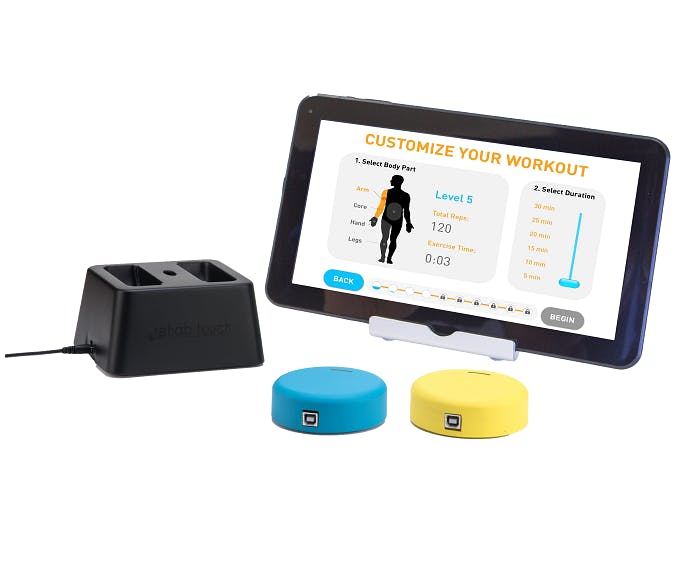FitMi blue and yellow "pucks" with tablet showing interactive neurorehabilitation software