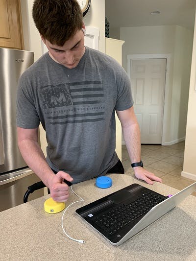 young man continuing his home exercise program for tbi using FitMi