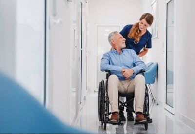 occupational therapist transporting spinal stroke patient in a wheelchair