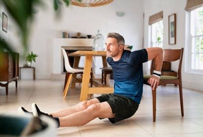 Survivor doing leg exercises at home to maximize stroke recovery.