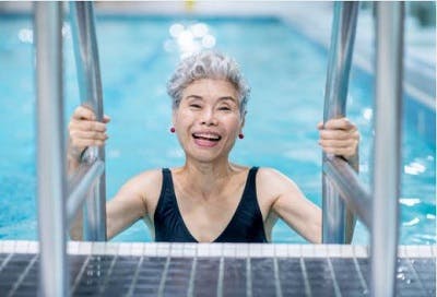 survivor happily engaging in aquatic therapy for spinal cord injury
