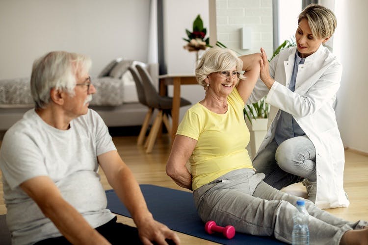 Therapist showing survivors how to accomplish their home exercise program for stroke recovery