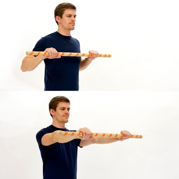 man holding a cane and doing a rowing exercise for spinal cord injury upper extremities