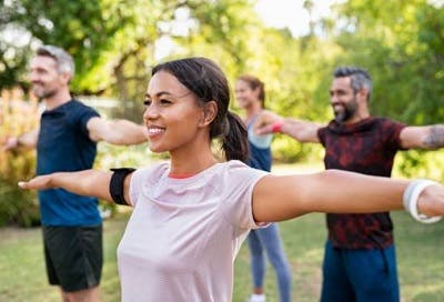 Group of individuals exercising happily after a TBI.