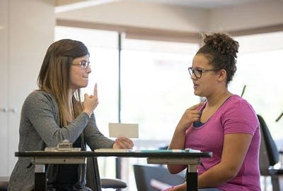 Therapist doing a cognitive speech activity with a TBI patient.